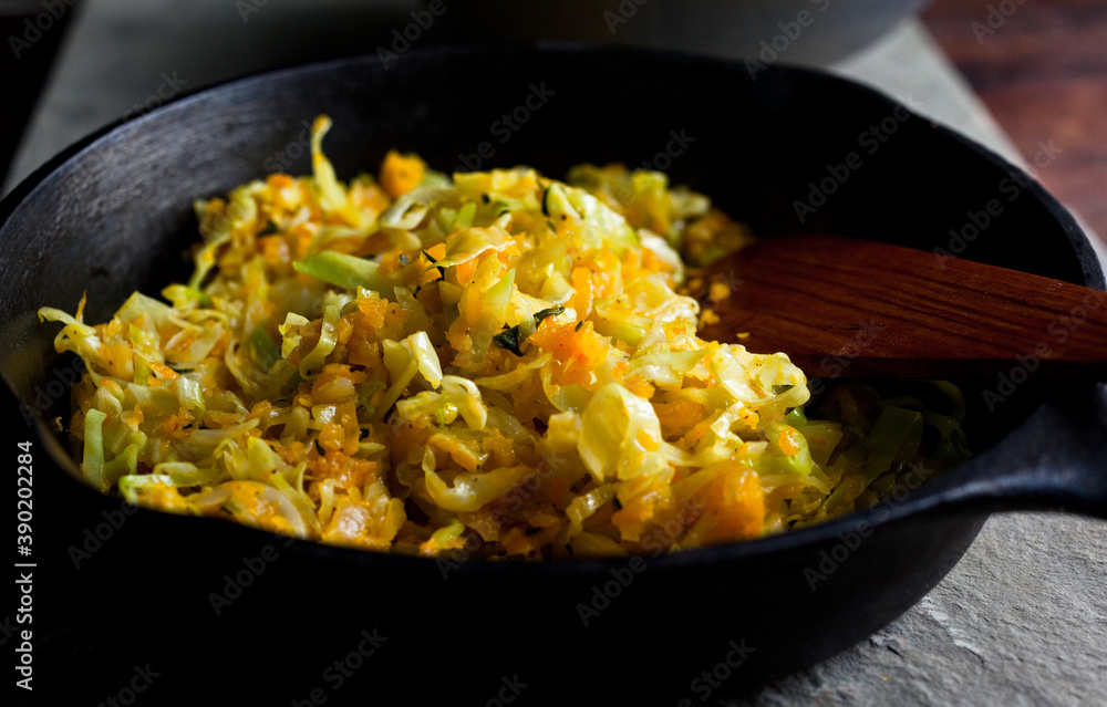 Close up of sauteed shredded winter squash and cabbage in frying pan Close up of sauteed shredded winter squash and cabbage in frying pan