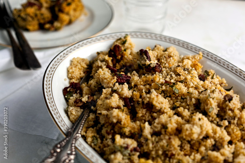 Close up of lemony couscous and pecan with parsley and garlic served in bowl