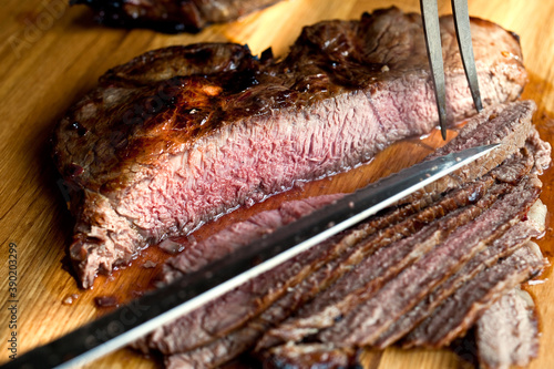 Close up of garlicky smoky grilled London broil flavored with chipotle chili