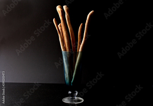 Close up of whole wheat and walnut breadsticks in glass