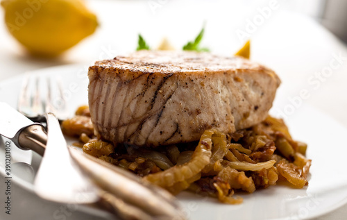 Close up of albacore steak with fennel served on plate photo