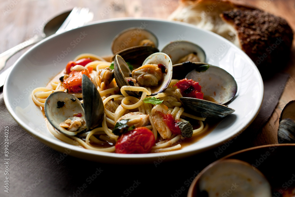 Close up of linguine with littleneck clams and roasted cherry tomatoes served on plate Close up of linguine with littleneck clams and roasted cherry tomatoes served on plate