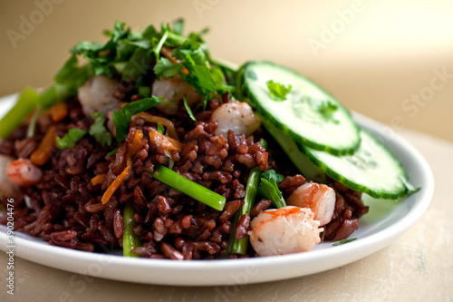 Close up of red Thai jasmine rice with shrimp served on plate photo