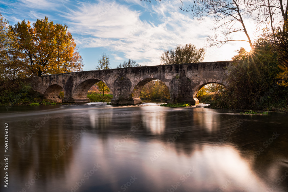 Bridge over river Altmühl lighten up in autumn mood, long exposure