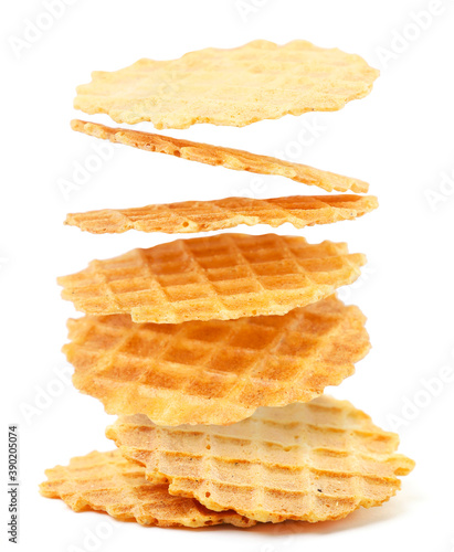 Italian waffles thin and crispy fly on a white background. Isolated levitating wafers photo