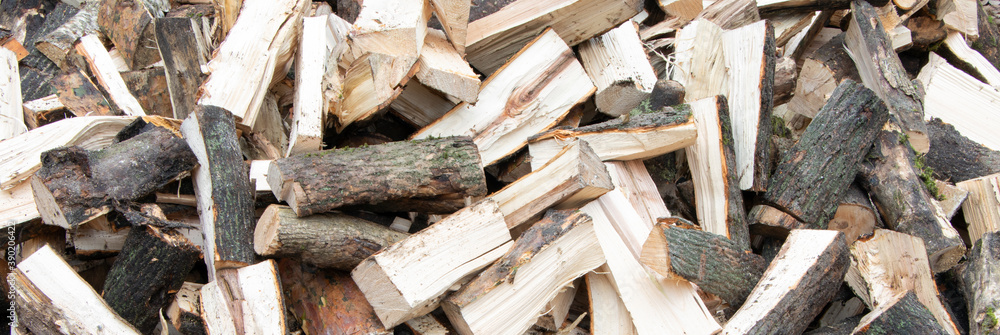 Banner. Heap of chopped firewood background. Pile of split firewood. Stack of fuel wood Banner. Heap of chopped firewood background. Pile of split firewood. Stack of fuel wood