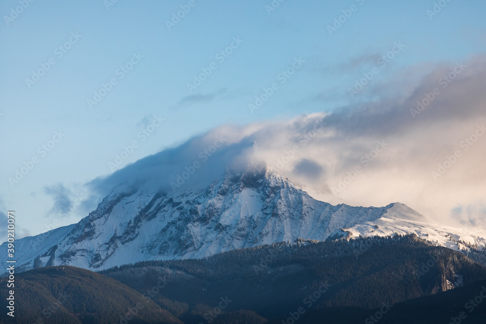 A snowy mountain peak at sunrise A snowy mountain peak at sunrise