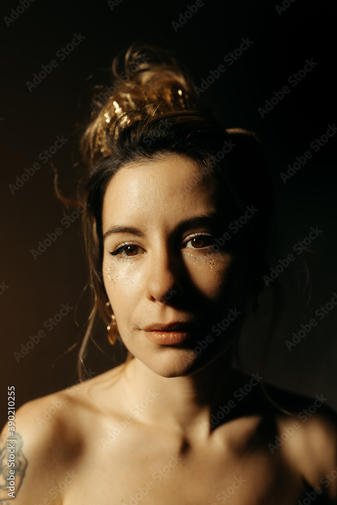 Portrait of young woman in golden tones Portrait of young woman in golden tones