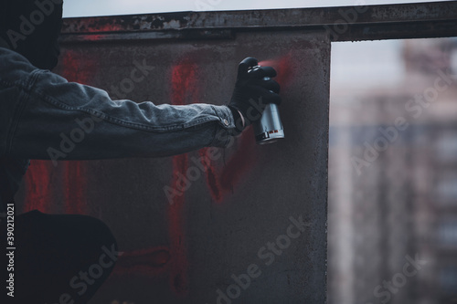 A hand in gloves of protester making sign in the old wall