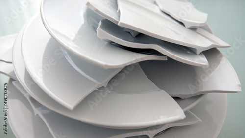 pile of broken white plates on glass table