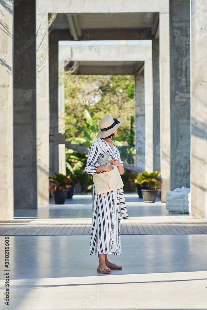 Elegant female traveler in trendy clothing at city street Elegant female traveler in trendy clothing at city street