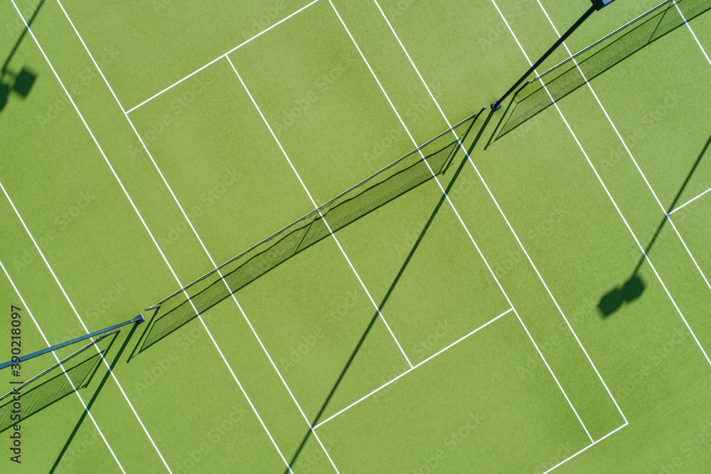 Aerial views over multiple artificial grass tennis courts Aerial views over multiple artificial grass tennis courts