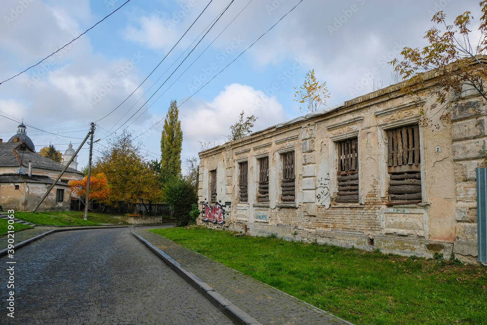 Old town street in autumn. Lutsk, Volyn, Ukraine. Restoration of an old house.