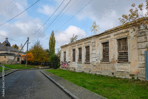 Old town street in autumn. Lutsk, Volyn, Ukraine. Restoration of an old house.