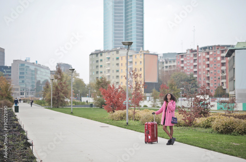 Wallpaper Mural young woman traveling with a trolley smokes a cigarette Torontodigital.ca