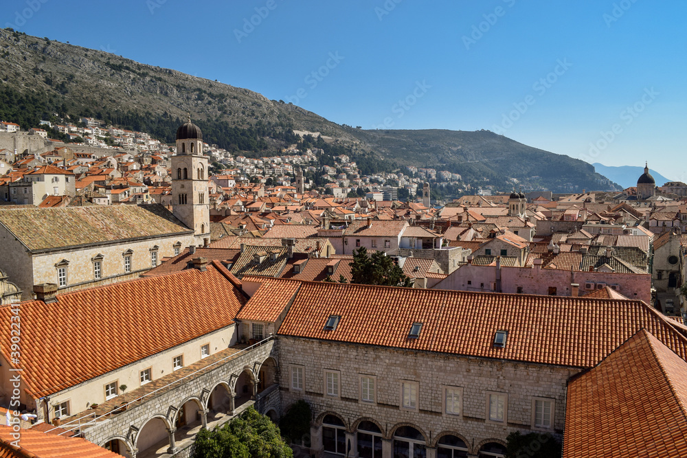 The beautiful old Dubrovnik seen from the top of the city walls. The day is beautiful and the sky is blue.