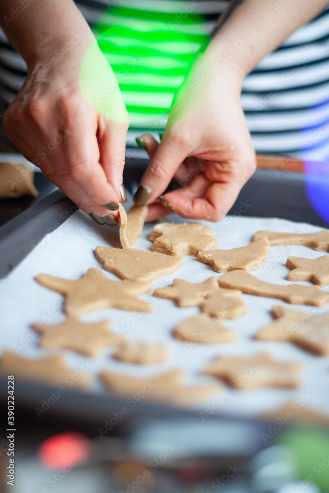Preparation of ginger biscuits. A woman cuts out cookies as a star shape. Pastry cooking, homemade cuisine concept. Preparation of ginger biscuits. A woman cuts out cookies as a star shape. Pastry cooking, homemade cuisine concept.