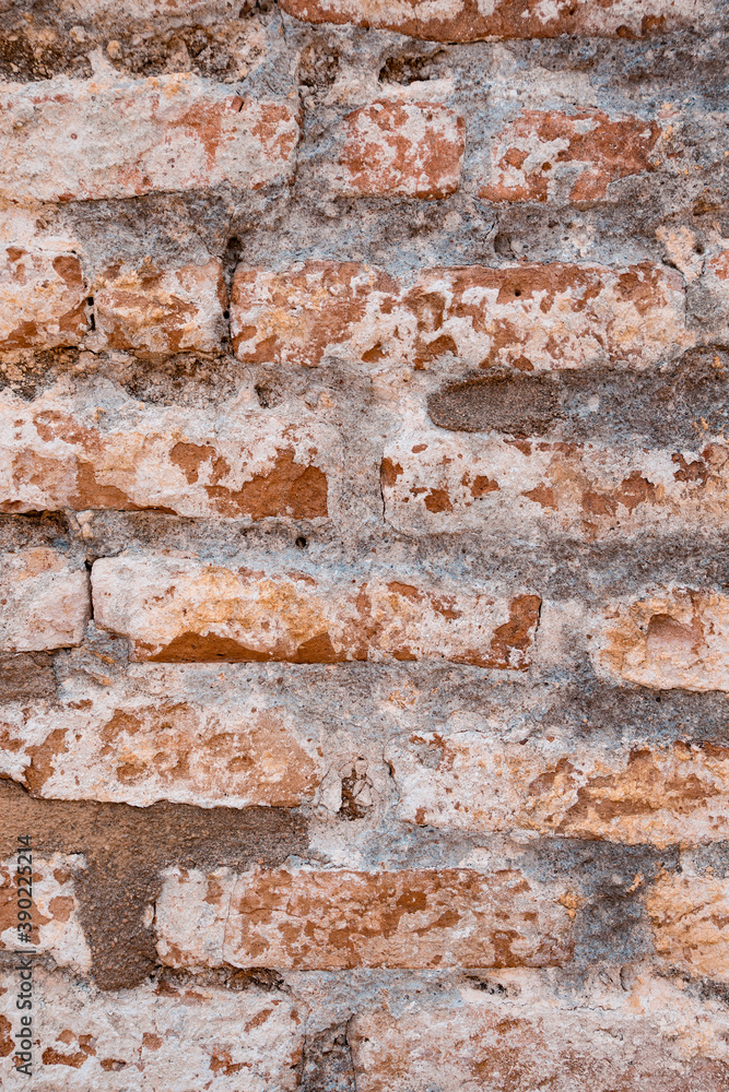Naklejka premium Background of old vintage dirty brick wall with peeling plaster, texture