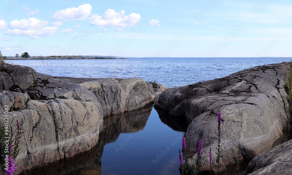 stone bathtub filled with water on a rocky island stone bathtub filled with water on a rocky island
