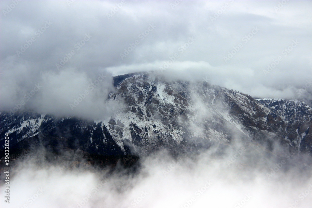 Snowy mountain peaks in the fog.