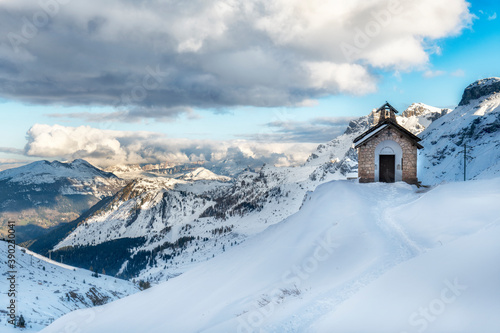 Winter day over the snow covered mountains and small chapel © Piotr Krzeslak