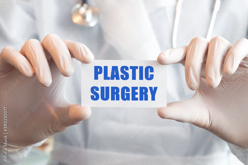 Doctor holding a card with text PLASTIC SURGERY, medical concept Doctor holding a card with text PLASTIC SURGERY, medical concept