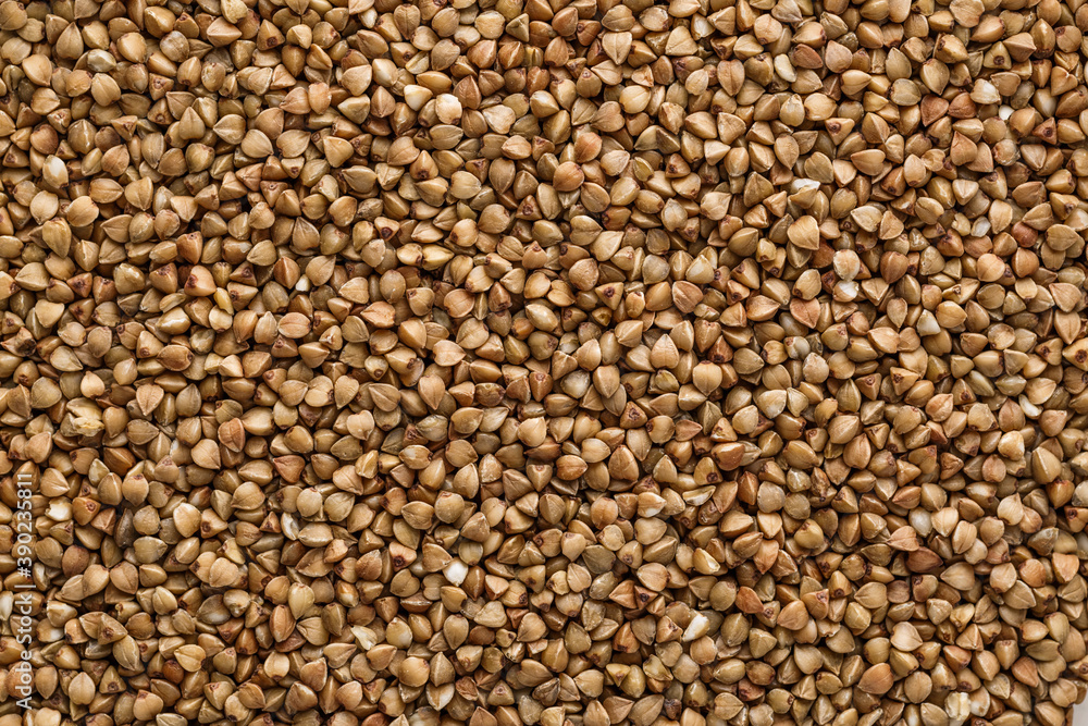 Buckwheat. The concept of diet and healthy eating, the background texture of the buckwheat. Macro photography of buckwheat texture.gluten free ancient grain for healthy diet,top view. Buckwheat. The concept of diet and healthy eating, the background texture of the buckwheat. Macro photography of buckwheat texture.gluten free ancient grain for healthy diet,top view.