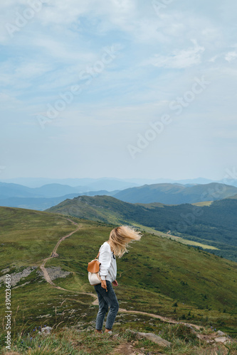 Beautiful nature landscape in mountains. Girl enjoy scenics view on valley. Hiking journey on tourist trail. Outdoor adventure. Travel and exploration. Healthy lifestyle, leisure activities
