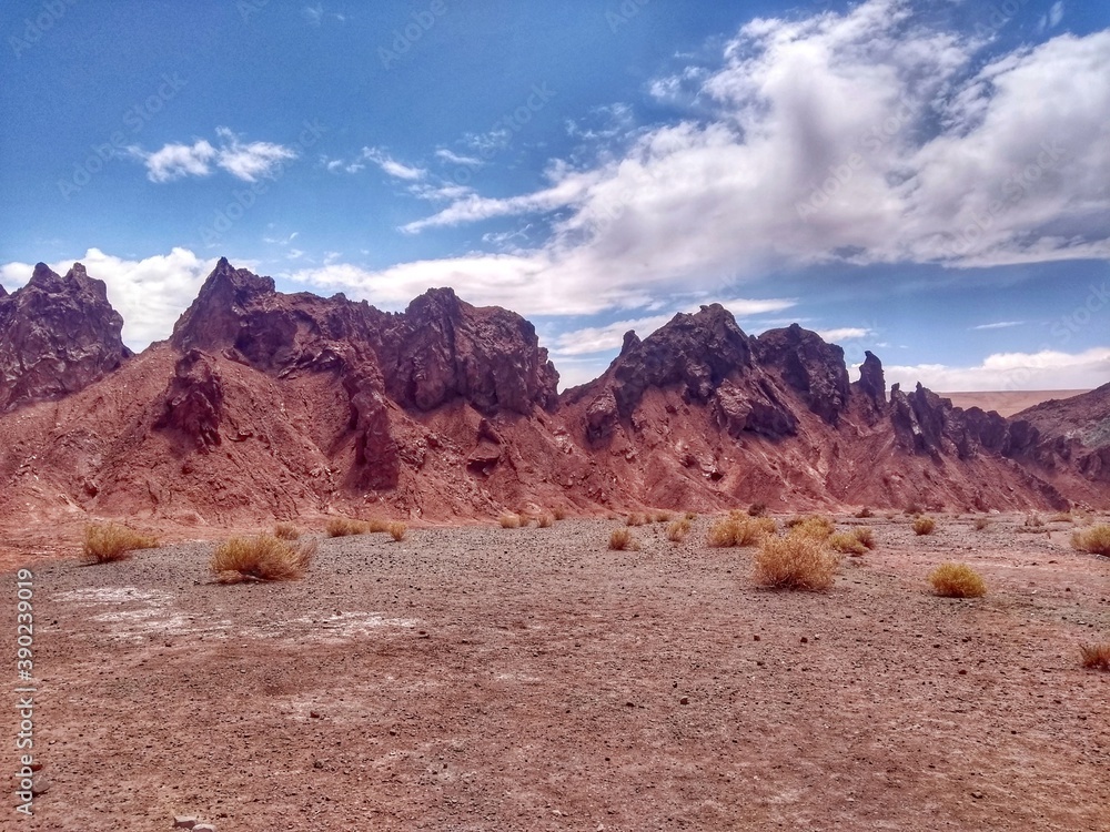 Fototapeta premium Yerbas Buenas, Valle del Arcoiris - Rainbow Valley, San Pedro de Atacama, Chile. Beautiful and colorful mountains in the Atacama desert, one of the driest places in the world. 