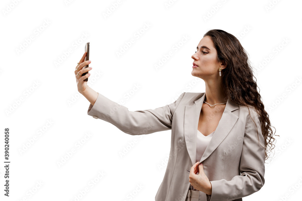 Young business woman does selfie isolated on white background. Attractive girl talking with her friends by video chats. On-line connection with family. Stay at home Young business woman does selfie isolated on white background. Attractive girl talking with her friends by video chats. On-line connection with family. Stay at home