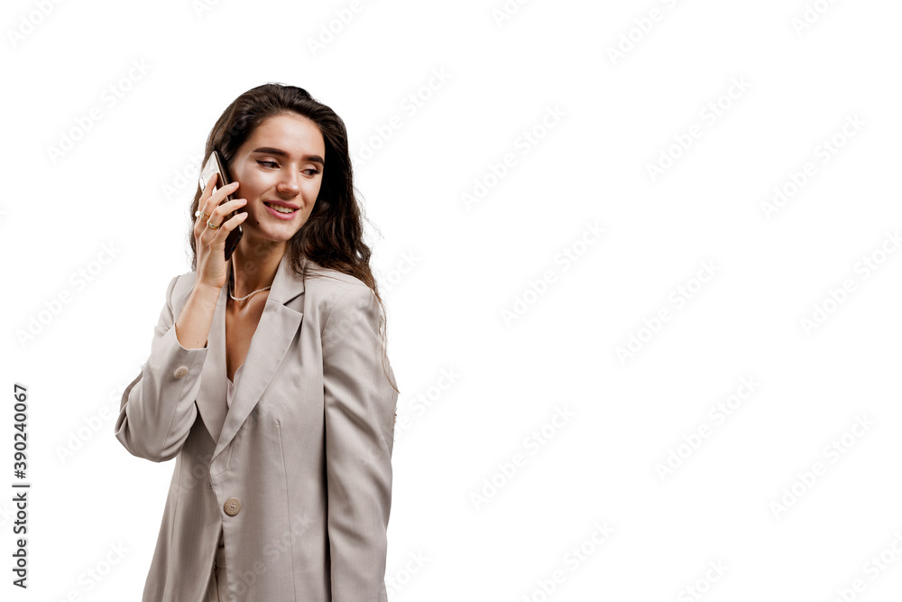 Business woman talking by phone isolated on white background. Communication with friends. Girl with curly hair weared white formal clothes Business woman talking by phone isolated on white background. Communication with friends. Girl with curly hair weared white formal clothes
