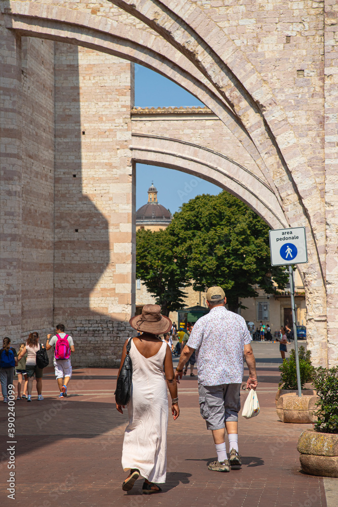 Tourists visit the famous town of Assisi, in Umbria (Italy)