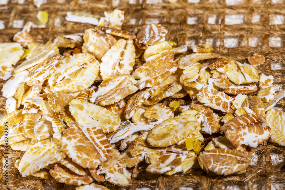 Oatmeal on burlap, oat flake cereal for making healthy breakfast Oatmeal on burlap, oat flake cereal for making healthy breakfast