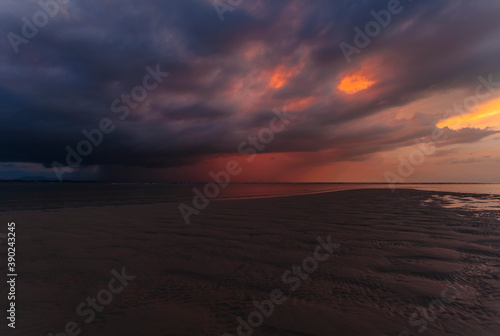 sea at tide under dramatic sunset sky