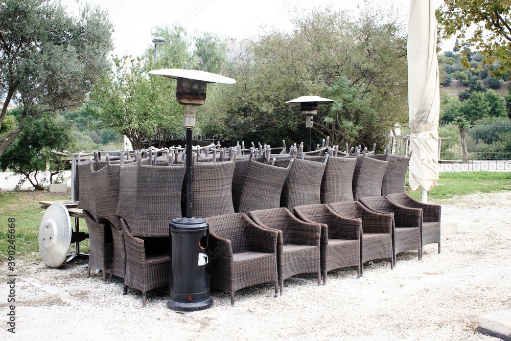 Greece, Athens, November 3 2020 - Chairs, tables and other furniture stacked outside closed cafe-restaurant, after the announcement for Covid-19 lockdown.