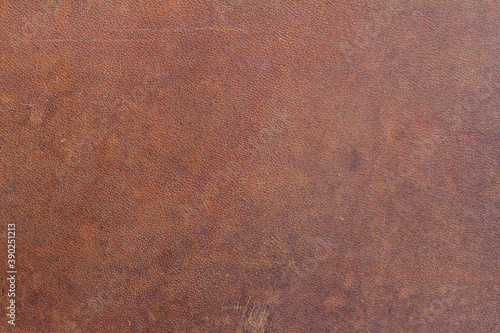 .Background of natural brown old saddle leather with spots