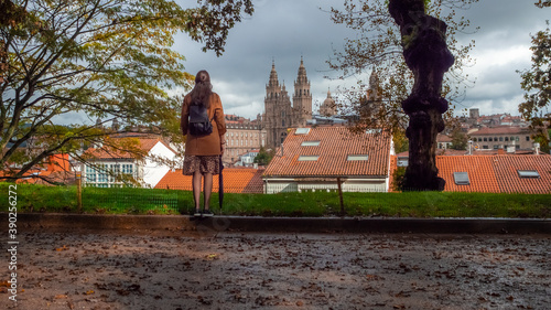 Closeup of a stylish female walking near the Cathedral of Santiago de Compostela in Spain