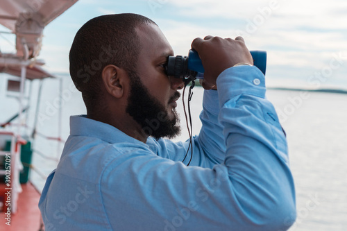 Captain holding binoculars in his hands