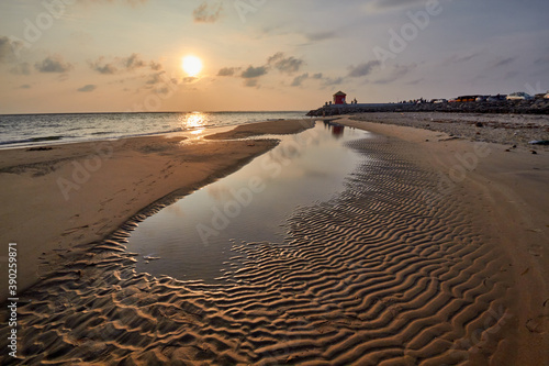 Strong natural patterns on Dutch beach during sunrise .
Scenic View Of Sea Against Sky During sunrise