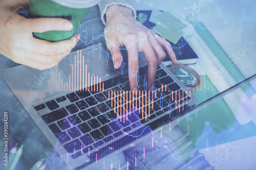 Double exposure of woman hands typing on computer and forex chart hologram drawing. Stock market invest concept.