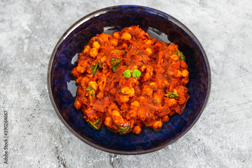 plant-based food, vegan moroccan chickpea stew with tomato sauce onion an carrots