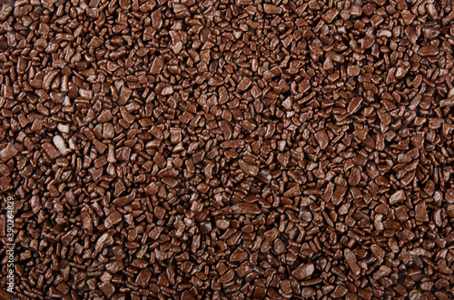 Chocolate sprinkles background. View of granulated chocolate.