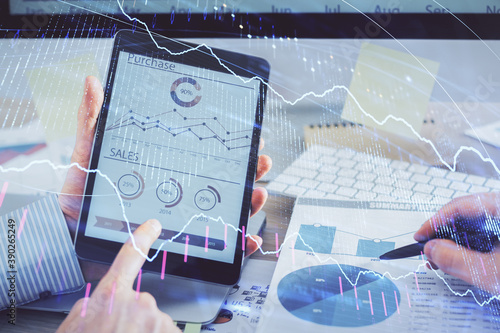 Multi exposure of man's hands holding and using a phone and financial chart drawing. Market analysis concept.