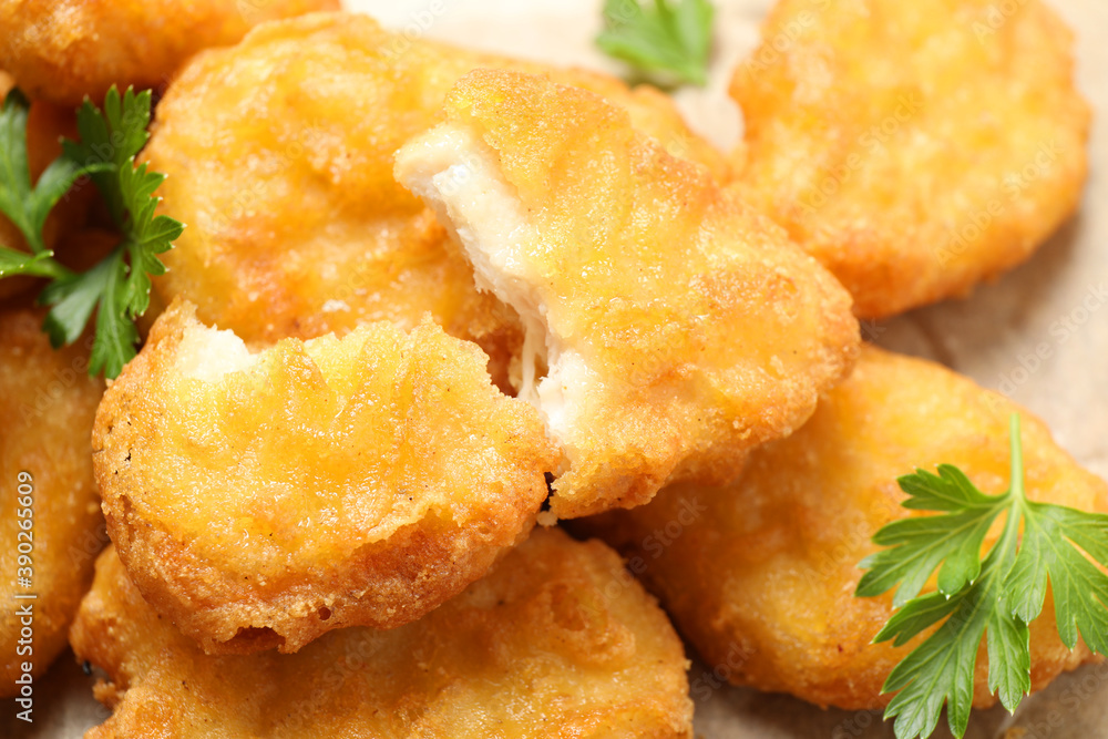 Tasty fried chicken nuggets on table, closeup Tasty fried chicken nuggets on table, closeup