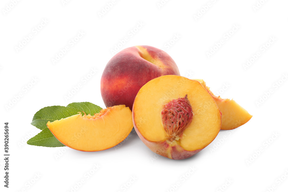 Whole and cut ripe peaches with leaves isolated on white Whole and cut ripe peaches with leaves isolated on white