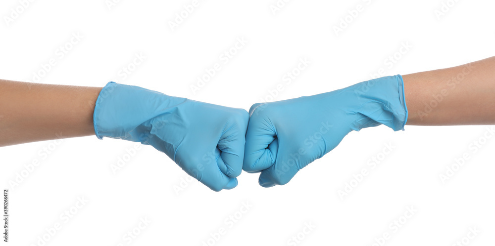 Doctors in medical gloves making fist bump on white background, closeup Doctors in medical gloves making fist bump on white background, closeup