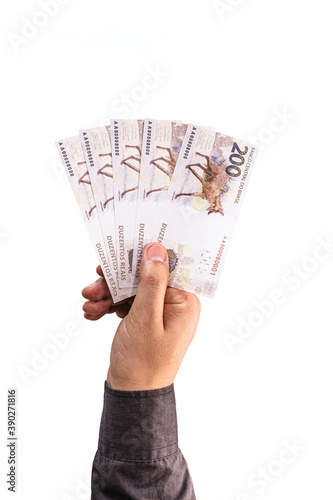 hand holding 200 reais bills, Brazilian money, fgts concept, emergency aid portion, or economy of brazil photo