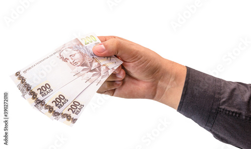 hand holding 200 reais bills, concept of brazil economy, inflation, financial crisis or loss photo
