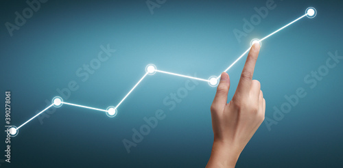 Hand touching a graphs of financial indicator accounting market economy analysis chart