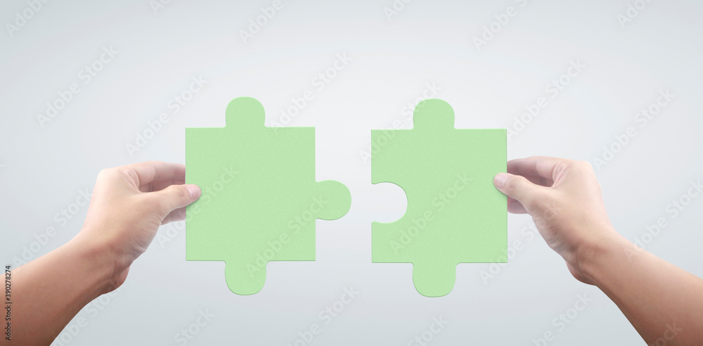 Hand of connecting jigsaw puzzle,Concept of teamwork Hand of connecting jigsaw puzzle,Concept of teamwork